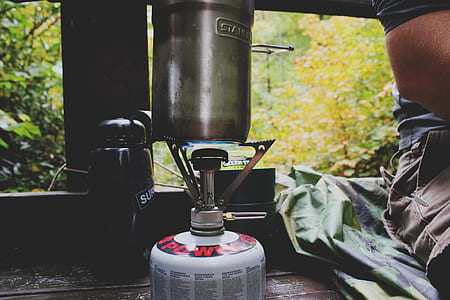 gray steel container on cylinder gas stove thumbnail