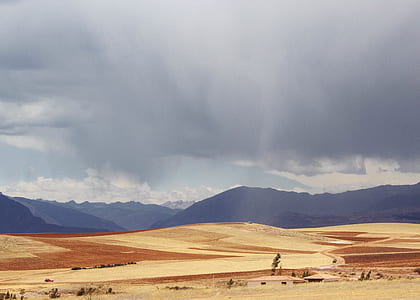 landscape photography of brown field far away from mountains thumbnail