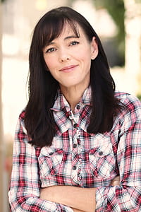 woman wearing red and white plaid sport shirt looking straight thumbnail