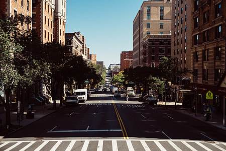 gray concrete roadway between storey buildings thumbnail