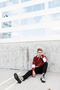 man leaning on grey concrete pavement thumbnail