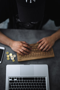 Young man typing on the wooden keyboard thumbnail