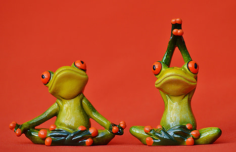 two green-and-brown frogs figurines on top red surface thumbnail