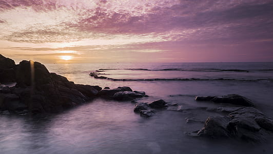 rock formation on body of water thumbnail