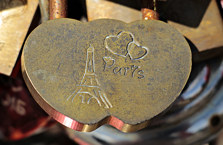 shallow focus photo of gold-colored Paris engraved accessory thumbnail