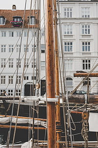 brown wooden sailboat stand during daytime photo thumbnail