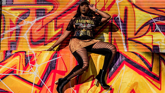 woman sitting on yellow and red concrete floor thumbnail