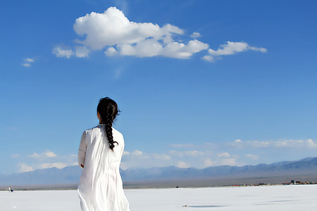woman in white long-sleeved dress standing during daytime thumbnail