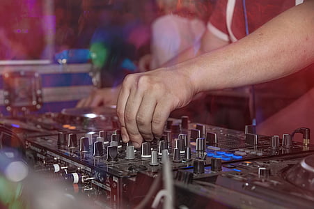 person holding DJ controller thumbnail