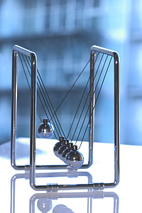 Newton's cradle on table thumbnail