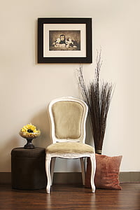 white wooden framed padded chair under painting with framed hanged on wall thumbnail