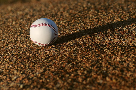 baseball on brown surface at daytime thumbnail