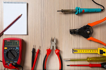 red and black digital multimeter near pliers thumbnail