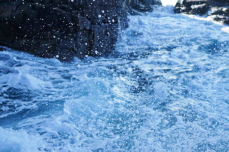 body of water beside rock formation thumbnail