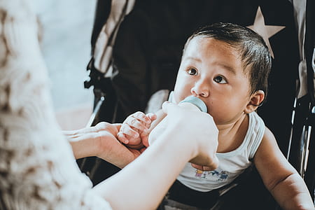 woman feeding child using feeding botttle thumbnail