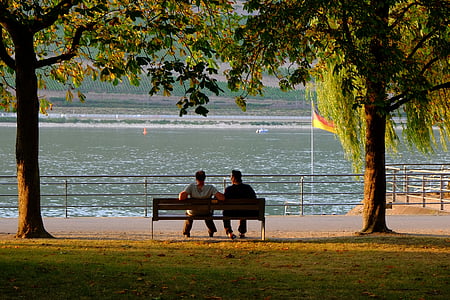 two people sitting on brown bench thumbnail