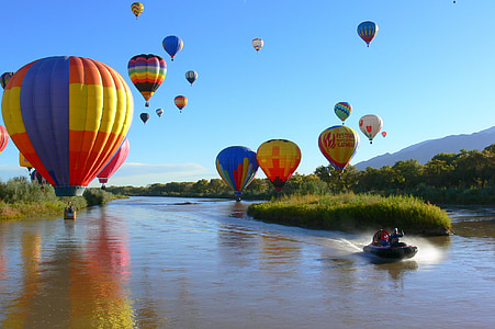 hot air balloons above body of water thumbnail