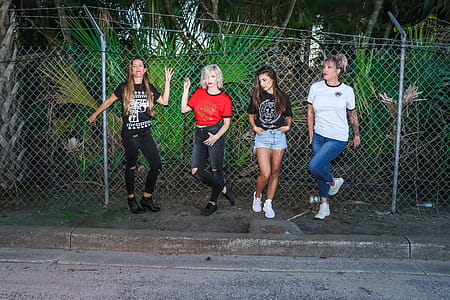 Group of Women Standing in Front Metal Fence thumbnail