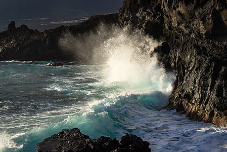 wave colliding to rock formation thumbnail