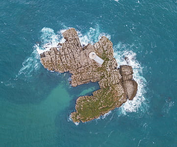 aerial photography of green and grey island thumbnail