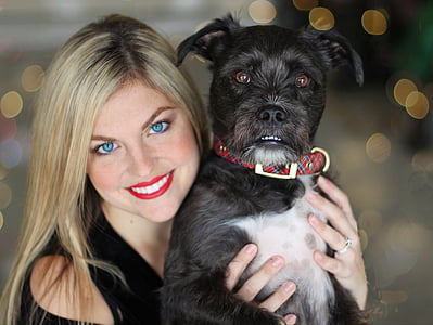 woman holding black and white dog thumbnail