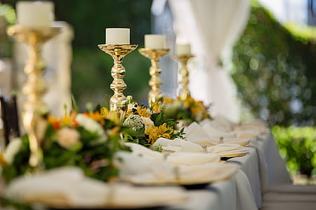 Four White Tealight Candles on Brass-colored Candlesticks thumbnail
