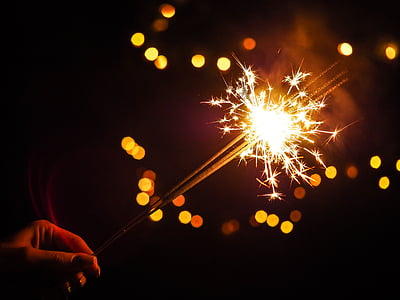 person lightning sparkler during night thumbnail