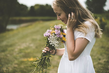 woman holding flower bouquet at daytime thumbnail