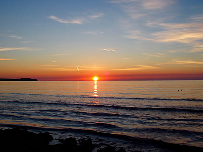 Body of Water With Orange Sun Setting during Golden Hour thumbnail