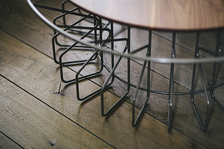Stylish home decor with a wooden round table and a bookcase thumbnail