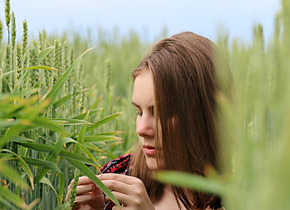 woman holding grain in middle of field thumbnail
