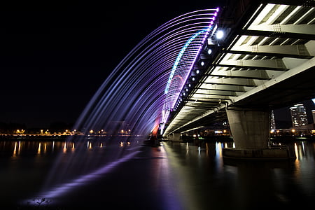 gray bridge at night time thumbnail