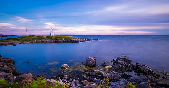 white lighthouse beside body of water thumbnail