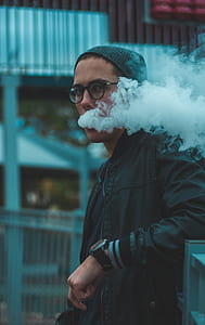 man leaning while smoke coming out in his mouth thumbnail