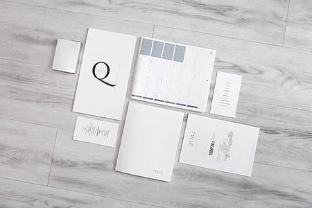 grayscale photo of calendars on hardwood floor tile thumbnail