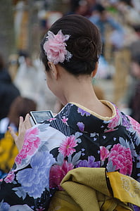 woman wearing black, purple, and pink floral top thumbnail