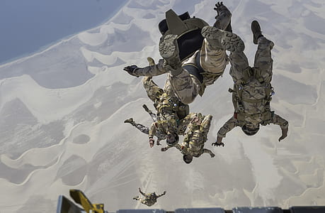 army performing skydiving exercise above desert thumbnail
