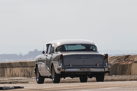 classic gray car on road under gray sky during daytime thumbnail