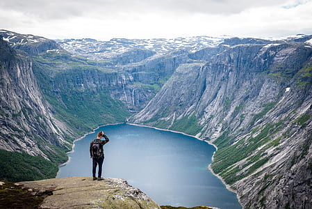 person on mountain cliff during day time thumbnail