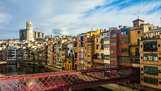 aerial photography of red metal bridge surrounded by buildings at daytime thumbnail