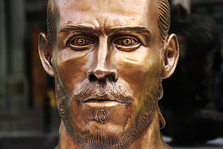 gold-colored man statue thumbnail