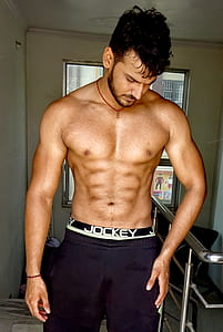 man wearing black and white jogging pants thumbnail