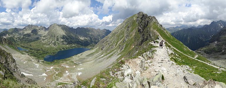 green tree covered mountains near lake at daytime thumbnail