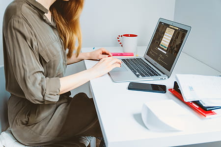Woman looking for a job online on laptop at home office thumbnail