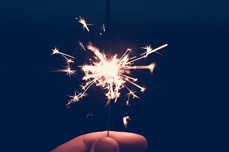 person holding lighted fire cracker thumbnail