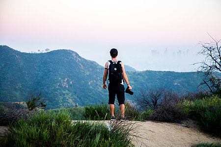 man standing while holding DSLR camera thumbnail