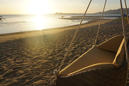 brown swing couch on beach thumbnail