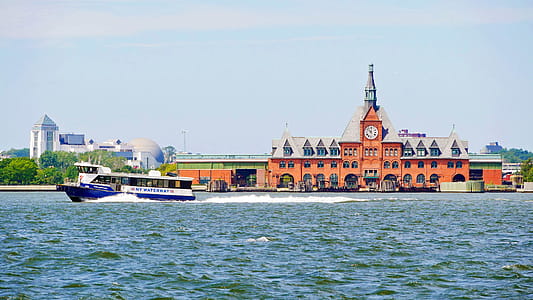 A NY Waterway motor boat cruises by the old CNJ Terminal at Liberty State Park. The ferries serving boats to Statue of Liberty National Monument, Ellis Island and Liberty Island leave from the State Park. Liberty Science Center can be seem further behind the boat. thumbnail