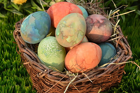 assorted-color Easter eggs on brown wicker basket thumbnail