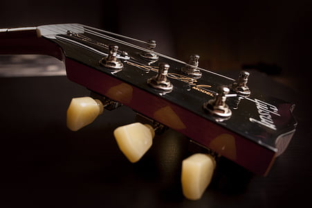 closeup photo of brown Gibson guitar headstock thumbnail